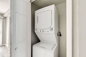 A white washing machine in a small room.